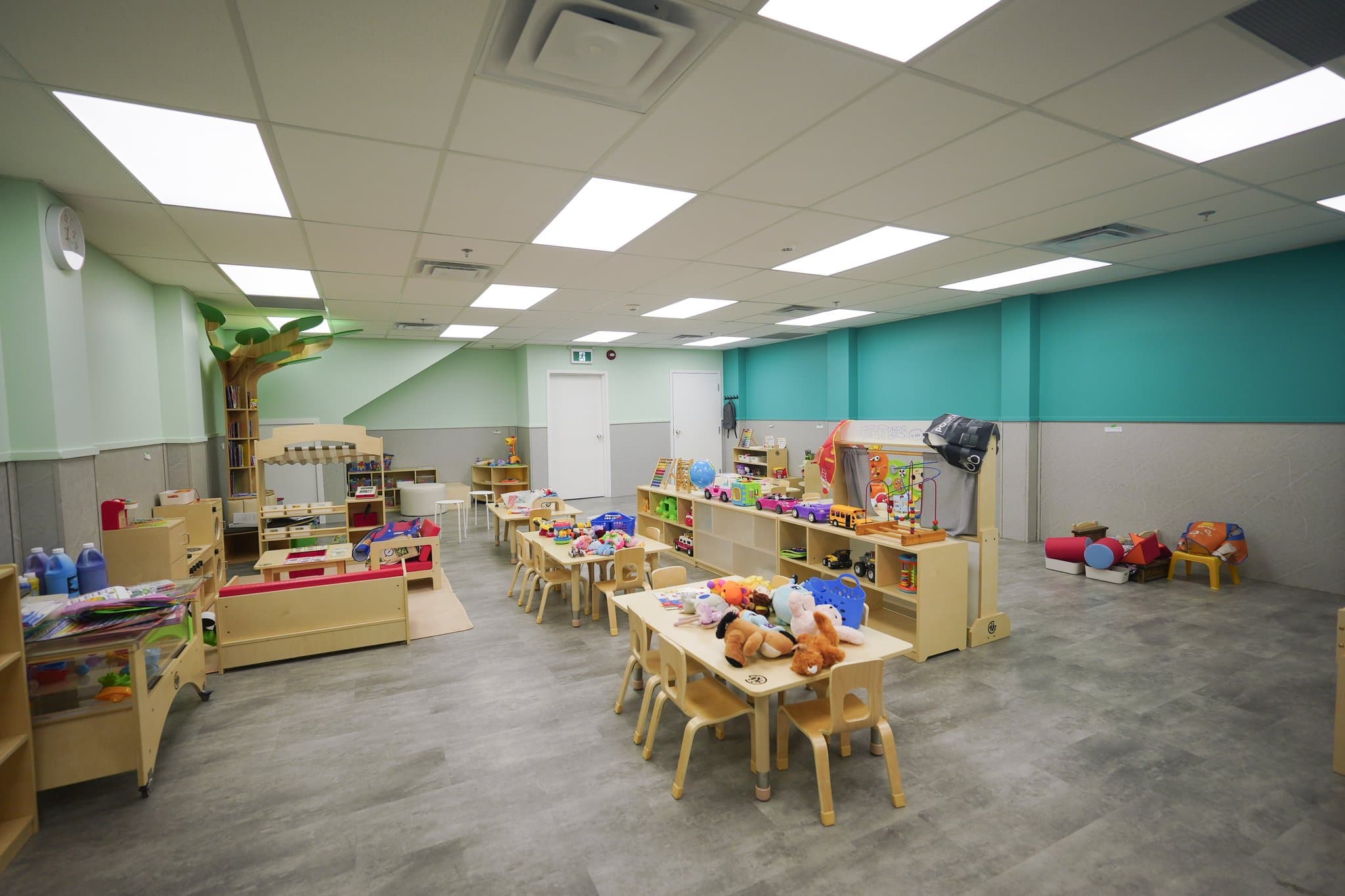 Toddlers classroom with educational play areas and child development materials at Tiny Genius Daycare Summerside
