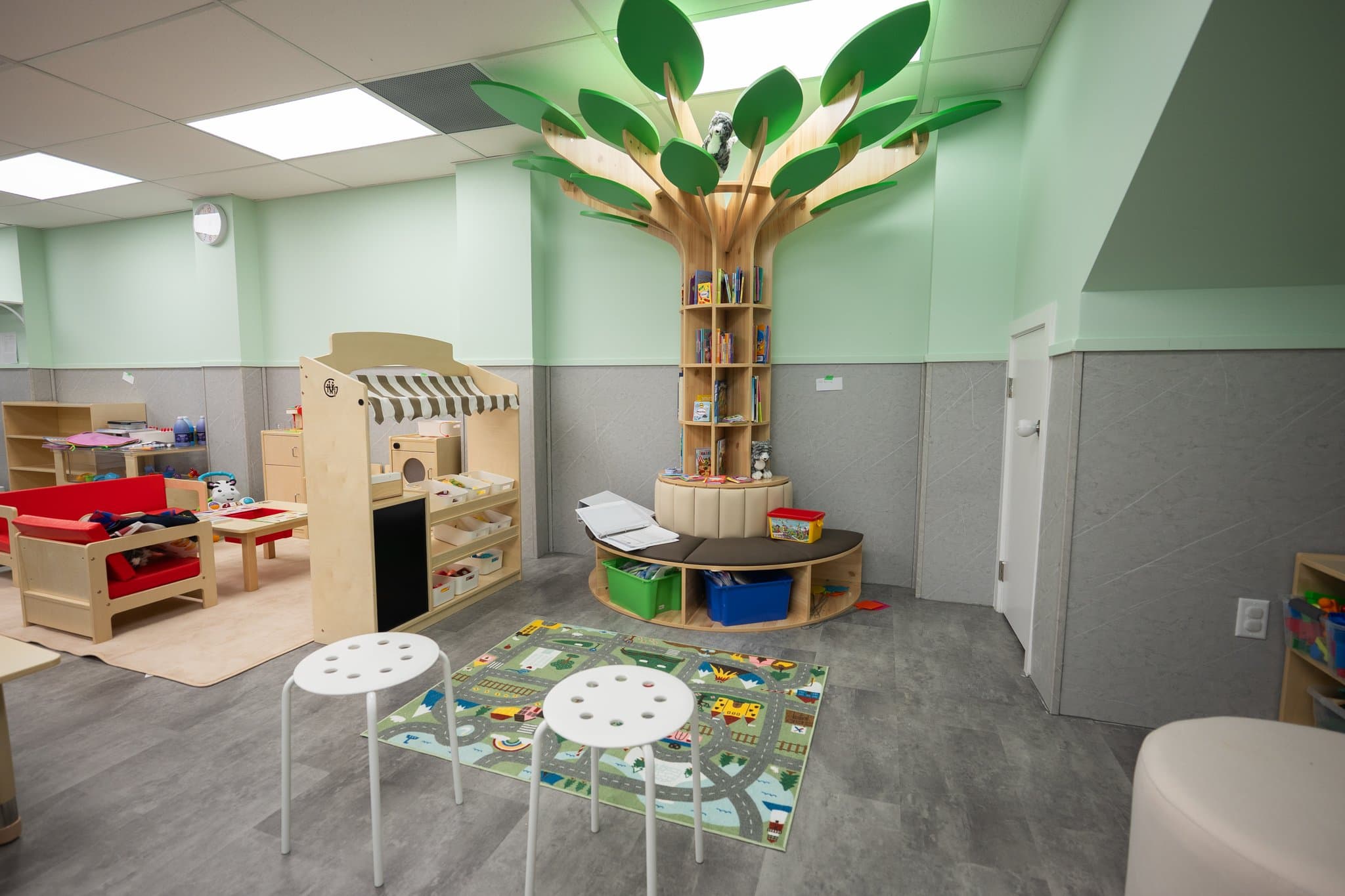 Custom wooden tree library and expansive indoor early learning play space at Tiny Genius Daycare Summerside Edmonton
