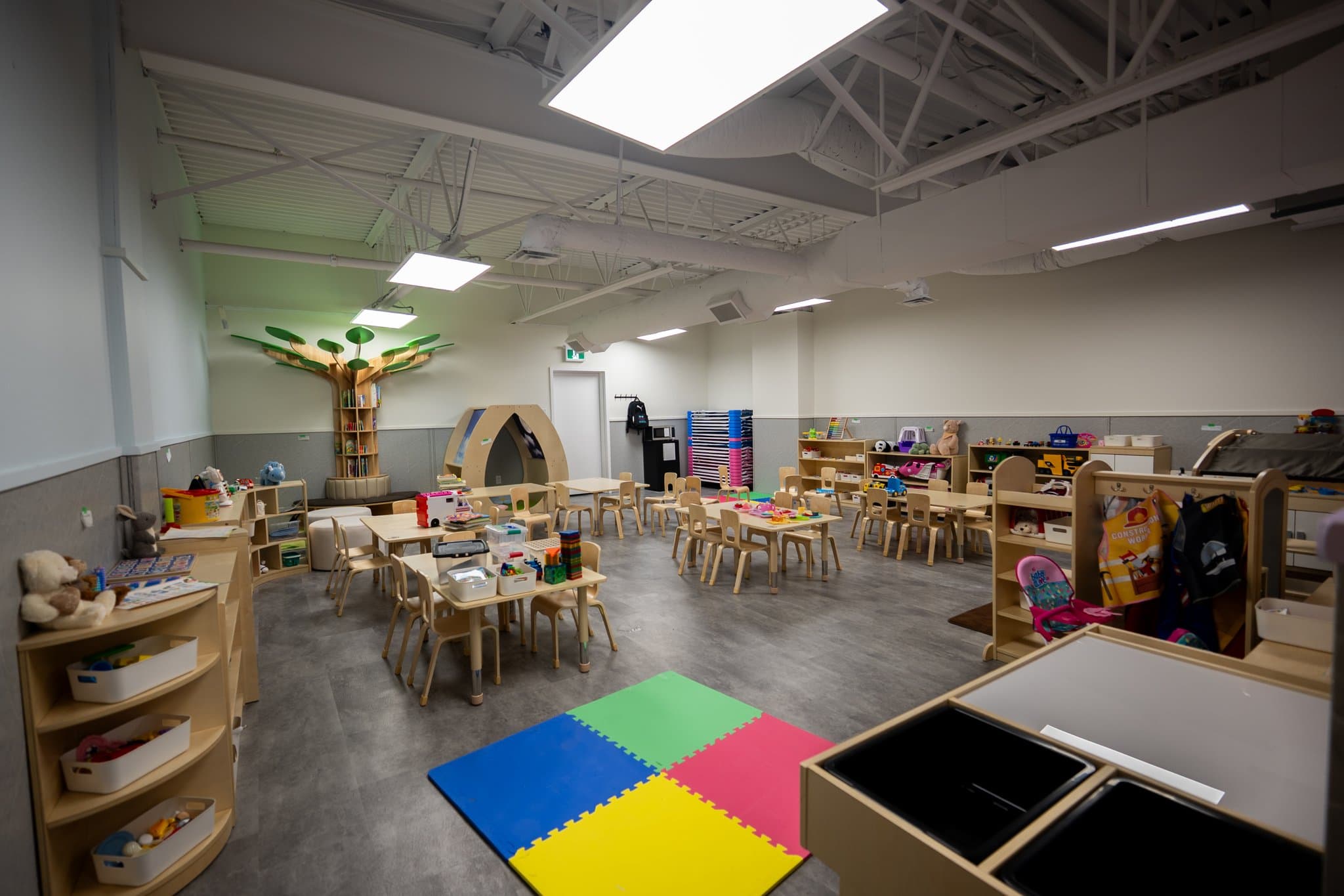 Preschoolers classroom with educational play areas and child development materials at Tiny Genius Daycare Summerside
