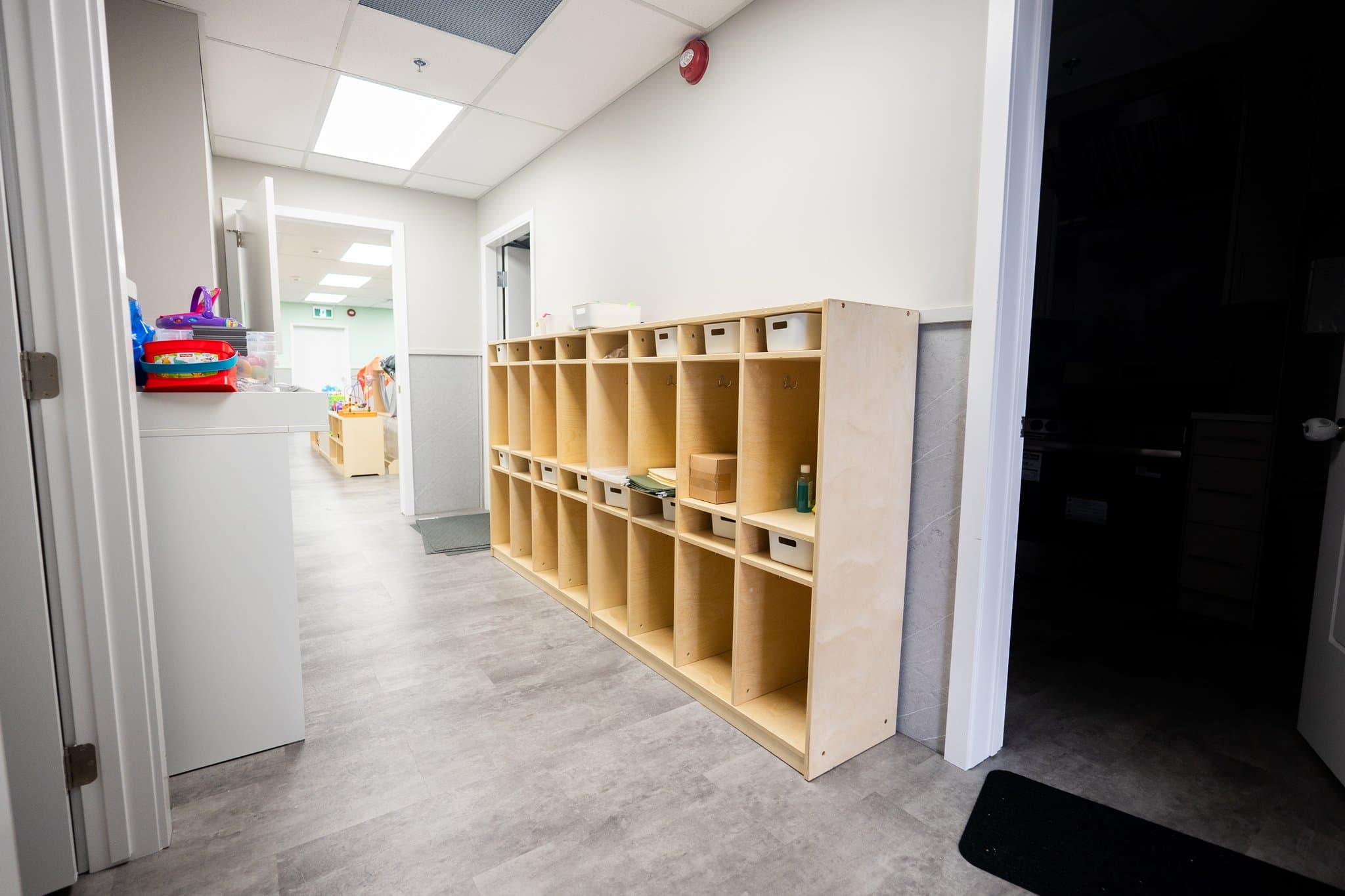 Hallway with designated individual child cubbies for backpacks and outerwear